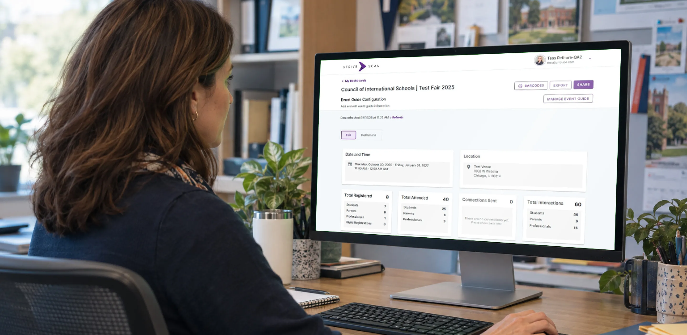A StriveScan administrator reviewing a fair's registration summary on a desktop monitor